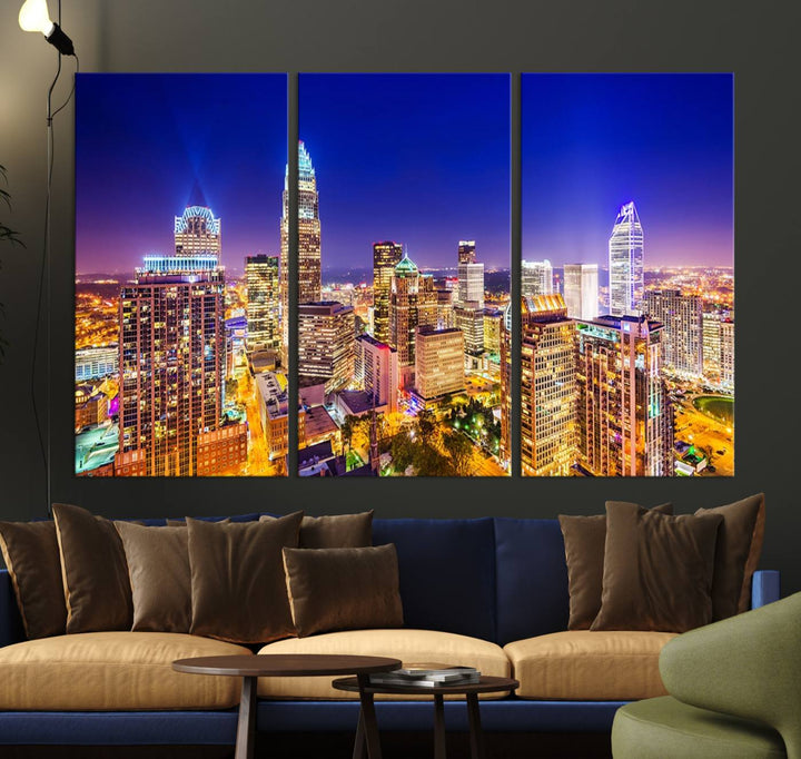 A modern living room features the Charlotte City Lights Night Blue Skyline Cityscape View wall art canvas print.