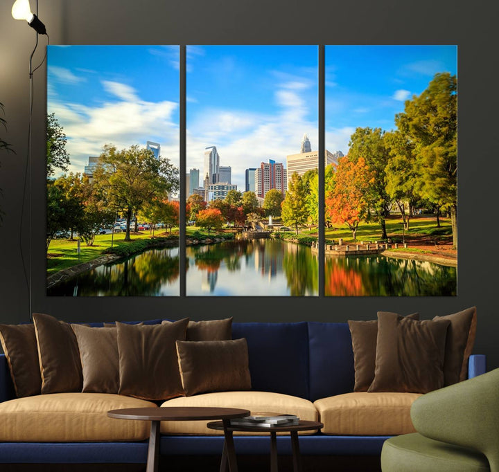 The Charlotte City Park at Spring Skyline Cityscape View wall art canvas print is a triptych featuring a scenic park with a lake and city skyline. It is gallery-wrapped on museum-quality canvases.