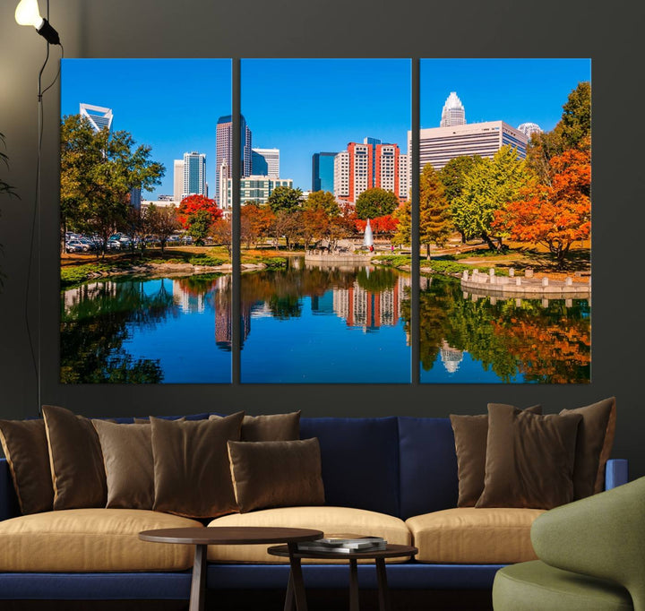 The "Charlotte City Autumn Morning Blue Skyline Cityscape View Wall Art Canvas Print" showcases a cityscape with vibrant autumn trees reflected in a lake. Its gallery-wrapped edges add depth to the scene, while the UV-protective coating ensures lasting brilliance.