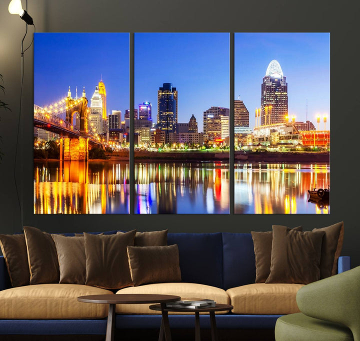 The "Cincinnati City Lights Night Skyline Cityscape View Wall Art Canvas Print" is a gallery-wrapped, museum-quality canvas illustrating a lit-up bridge and skyline at night. Enhanced with a UV-protective coating, this piece ensures lasting vibrancy.