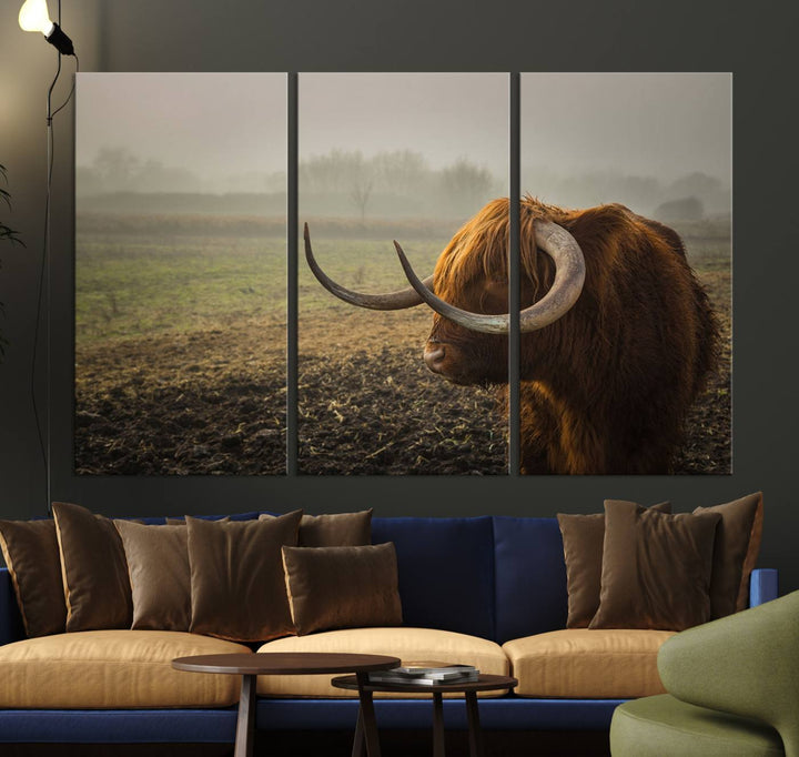 The "Big Cow Horn Wall Art Canvas Print" is a hand-assembled framed canvas depicting a Highland cow in a misty field. It is crafted with a UV-protective coating to ensure lasting vibrancy.