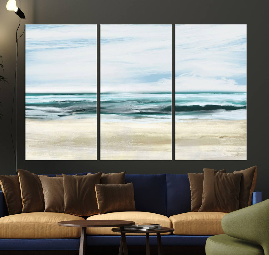 The room features the Ocean Abstract Wall Art Canvas Print, a triptych beach painting on museum-quality canvas with a gallery-wrapped finish and UV-protective coating.