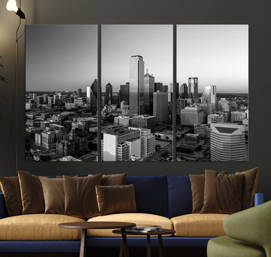 A modern living room showcases the Dallas City Lights Skyline Black and White Wall Art Cityscape Canvas Print. This gallery-wrapped piece offers a sleek finish and is crafted from museum-quality pollycotton. It features a UV-protective coating to ensure lasting vibrancy.