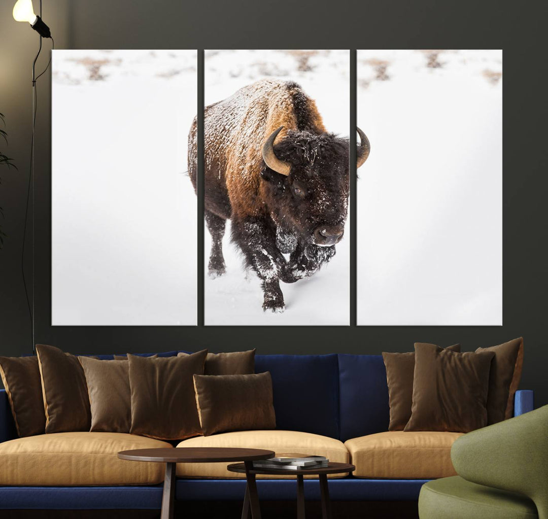 The Bison Winter Wall Art Canvas Print for Farmhouse Decor is displayed as a triptych in the living room. This artwork, printed on museum-quality canvases with a UV-protective coating to maintain its vibrant colors, is the focal point of the space.