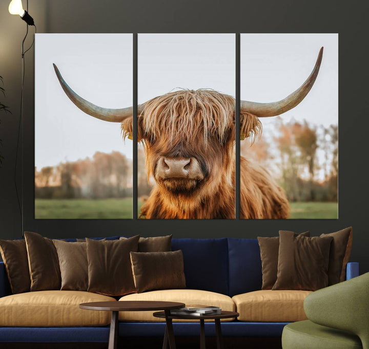 A Highland Cow Animal Scottish Cattle Art Print Farmhouse Wall Art Canvas Print hangs in the living room, adding a touch of rustic farmhouse decor.