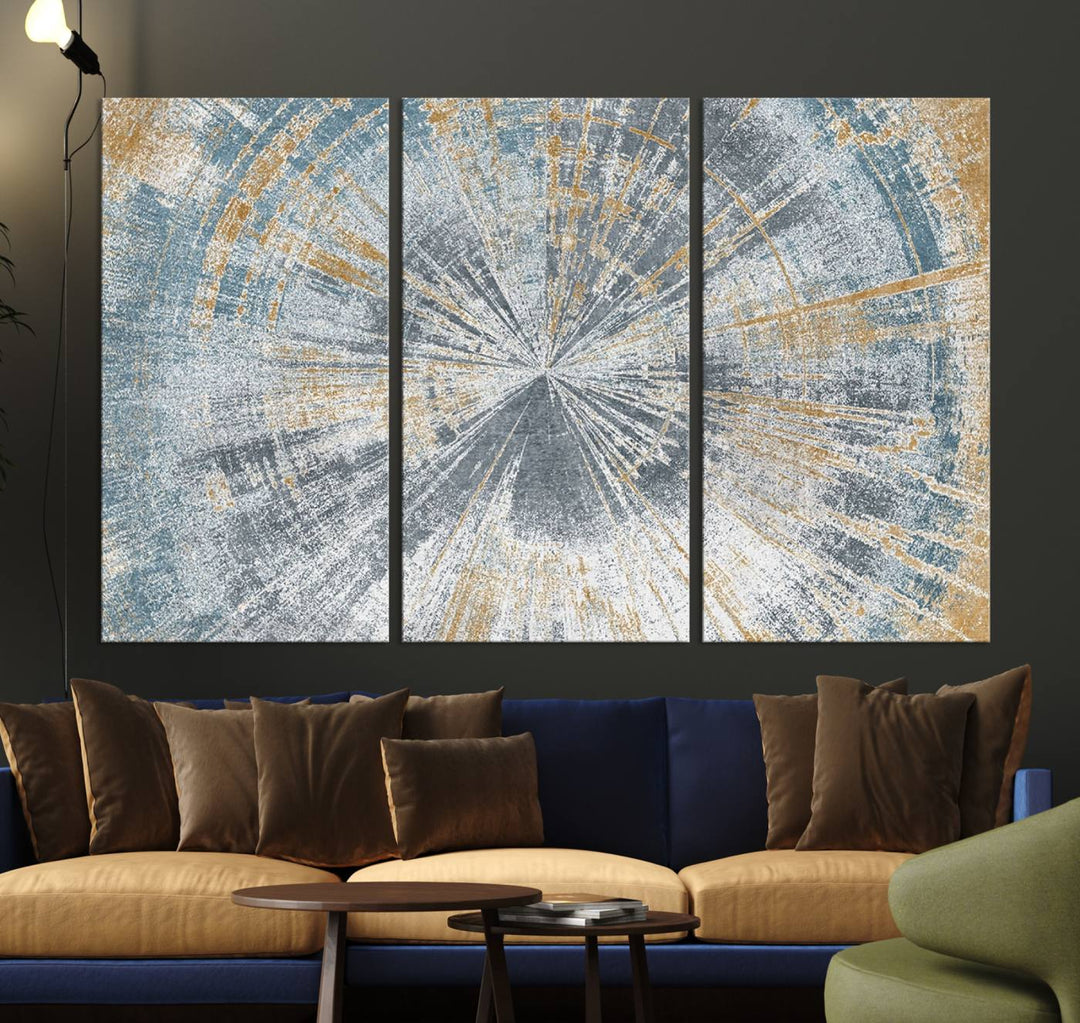 The Radiant Abstract Wood Rings Canvas Art, a modern triptych wall decor, enhances the contemporary style of the living room with its blue, white, and gold hues.