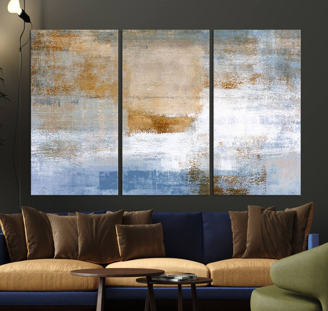 The Blue Multi Panel Abstract Wall Art Canvas Print, featuring an elegant blend of blue, beige, and brown tones, hangs gracefully on the wall, adding a contemporary touch to the space.