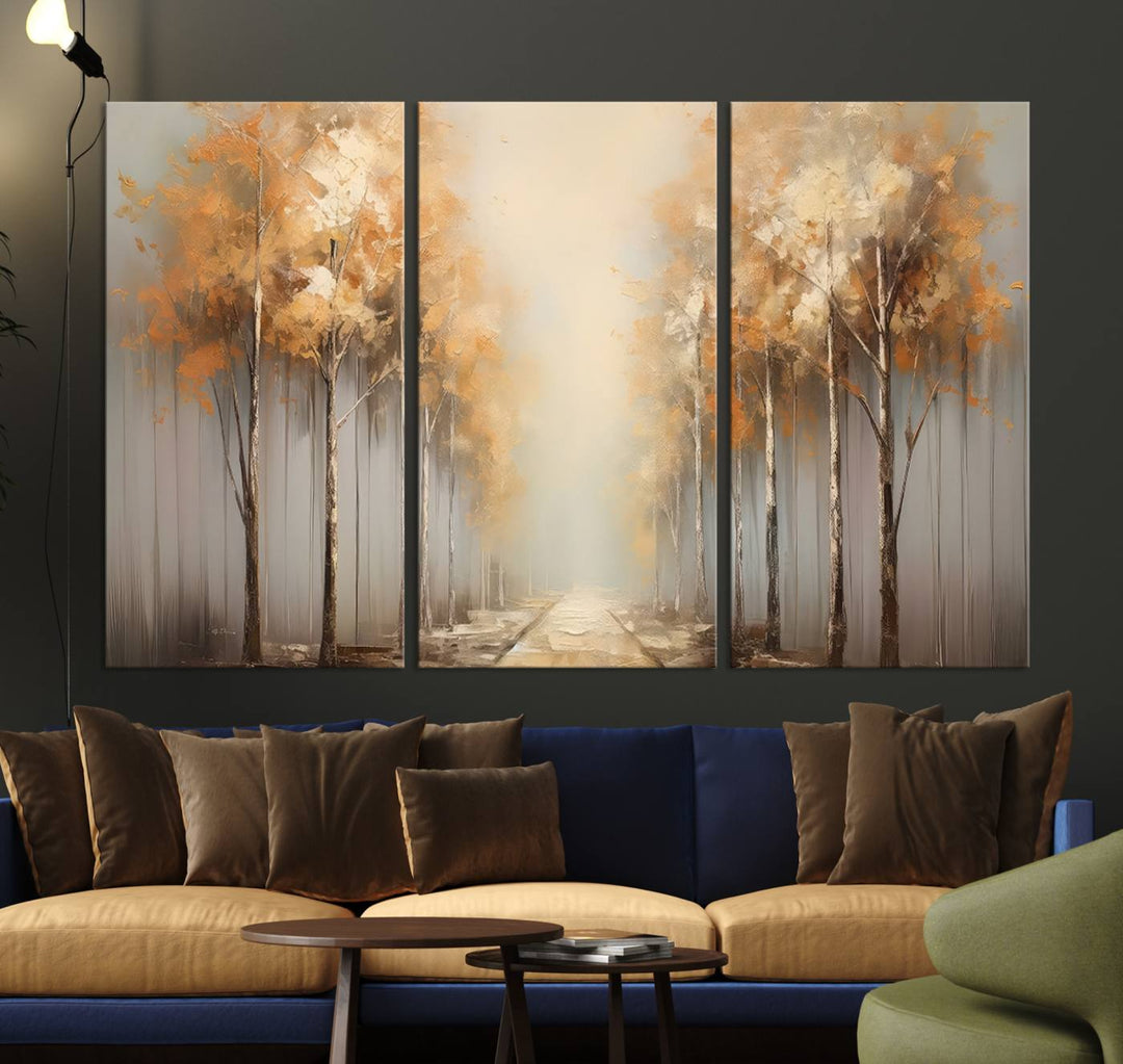 A breathtaking Autumn Forest Path Wall Art, a large canvas print perfect for the living room, bedroom, or office decor, elegantly enhances the area above a white sofa.