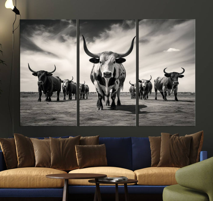 The Black and White Longhorn Cattle Wall Art, featuring a three-panel display of cowboy Western longhorns walking toward the viewer, enhances your space with its striking presence, adding a touch of Western decor.