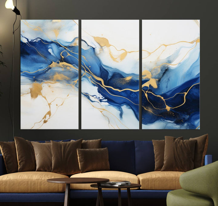 The Blue Abstract Wall Art is displayed as a triptych on museum-quality canvas, showcasing a blue and gold abstract design. The artwork includes a UV-protective coating to maintain its vibrancy and comes with the benefit of free shipping.