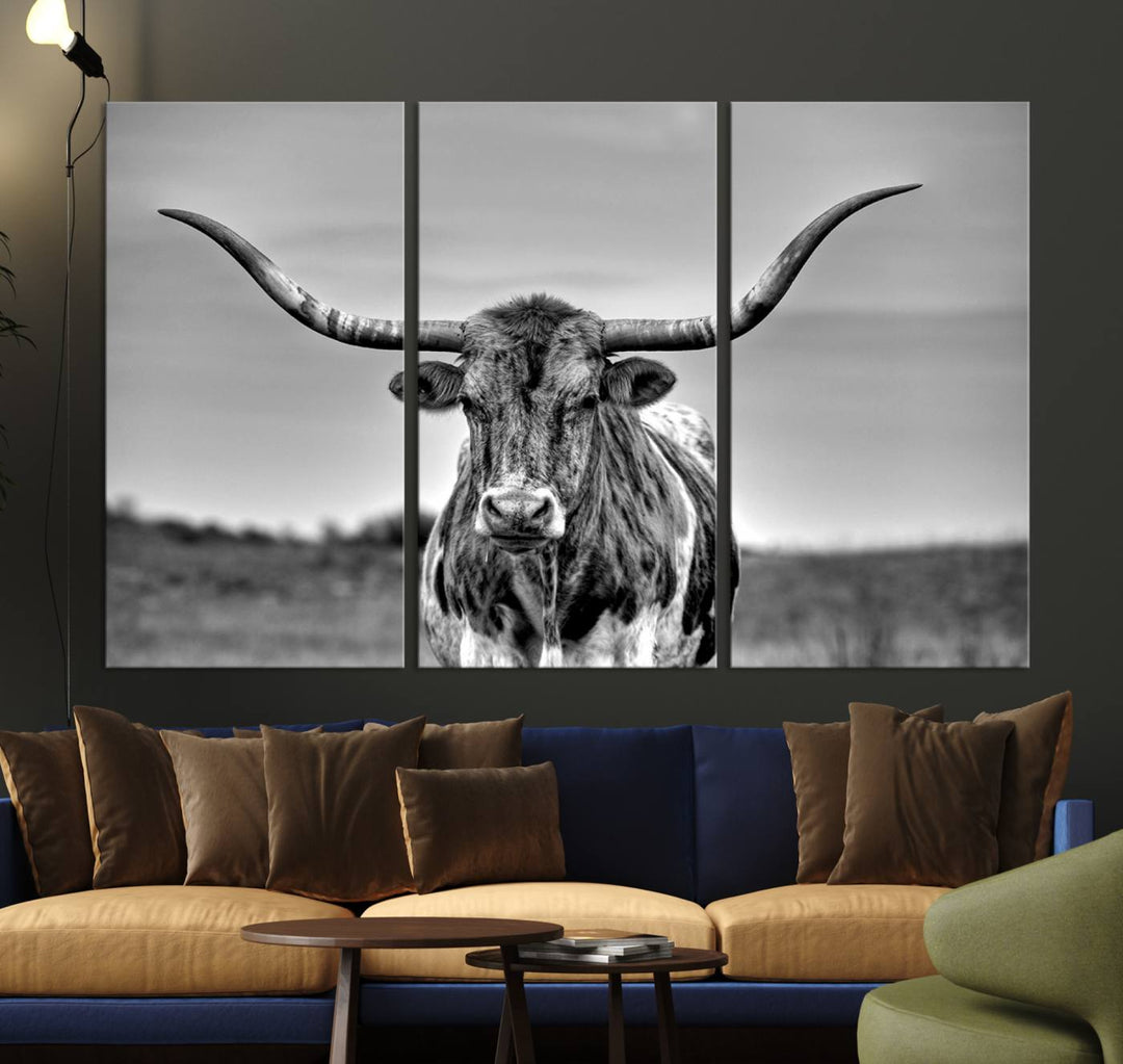 The Texas Longhorn Cow Wall Art, featuring a black and white image of a longhorn bull on canvas, brings charm to the room with its sophisticated appeal.