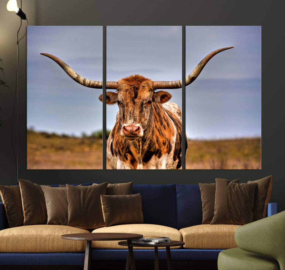 The Texas Longhorn Wall Art Print, a triptych canvas artwork depicting a longhorn bull in a field, features a gallery-quality finish.