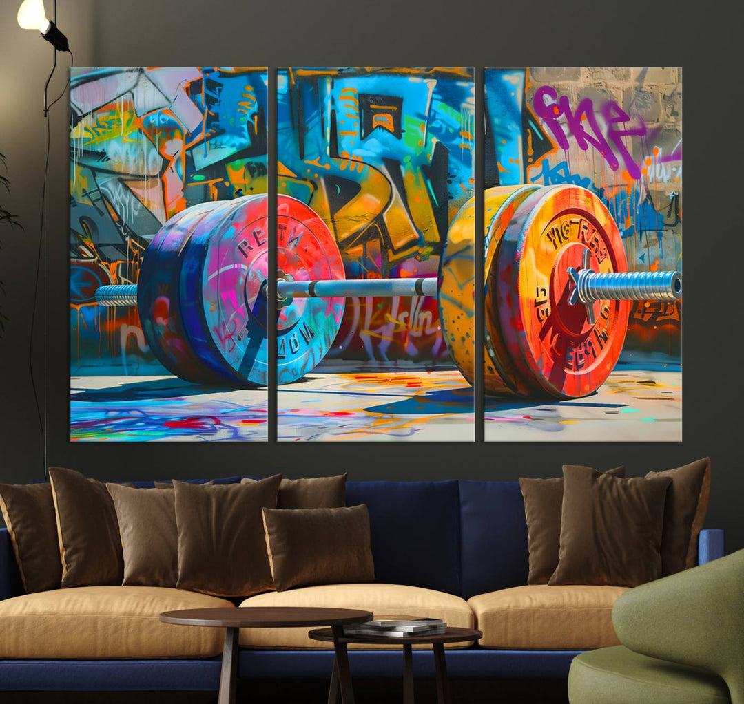 The Fitness Gym Barbell Graffiti Wall Art Canvas Print, a vibrant triptych featuring a barbell against a graffiti backdrop, elegantly hangs in the room. Crafted on premium canvas with a gallery-quality finish, this stunning piece of wall art effortlessly combines urban flair with sophisticated decor.