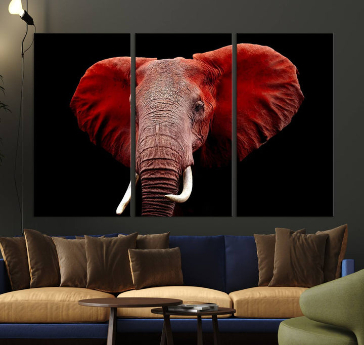 A Wall Art Canvas Print in the modern living room features a three-panel premium design of a red elephant face.