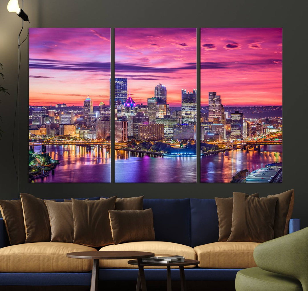 The Pittsburg Wall Art Canvas Print, showcasing a vibrant sunset glow over the city skyline and crafted by a professional artisan, adorns the space.