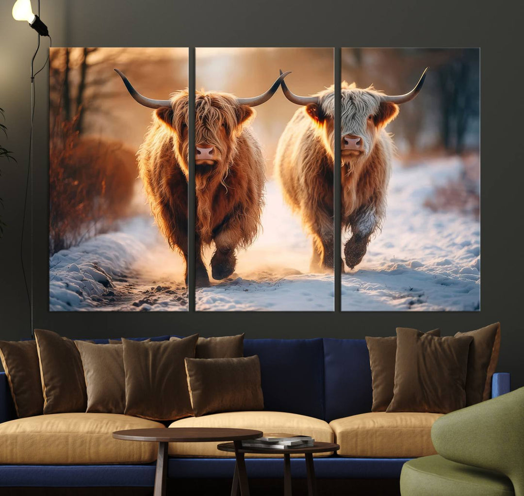 The living room showcases a triptych from the Scottish Highland Cow Horn Farm Wall Art Canvas Print collection, depicting two Highland cows running in the snow. Complementing this are handmade wall art pieces with a gallery-quality finish that add an elegant touch.