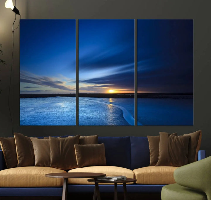 The living room features a triptych of the Wall Art Canvas Print Navy Sunset Lake Landscape Artwork, adding to its tranquil vibe.