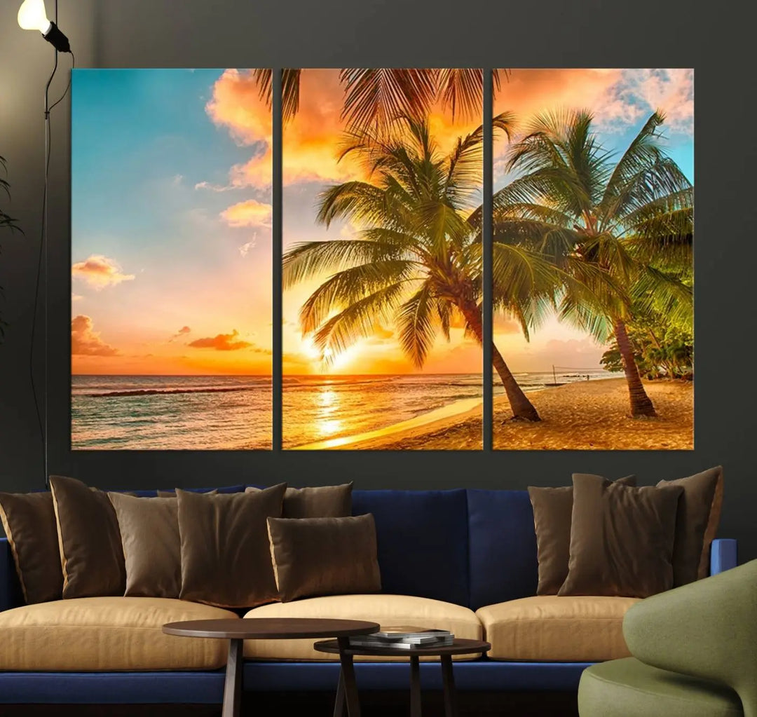 The Tropical Sunset Wall Art Print features a vibrant beach scene with palm trees and an ocean view highlighted by a golden sunset.