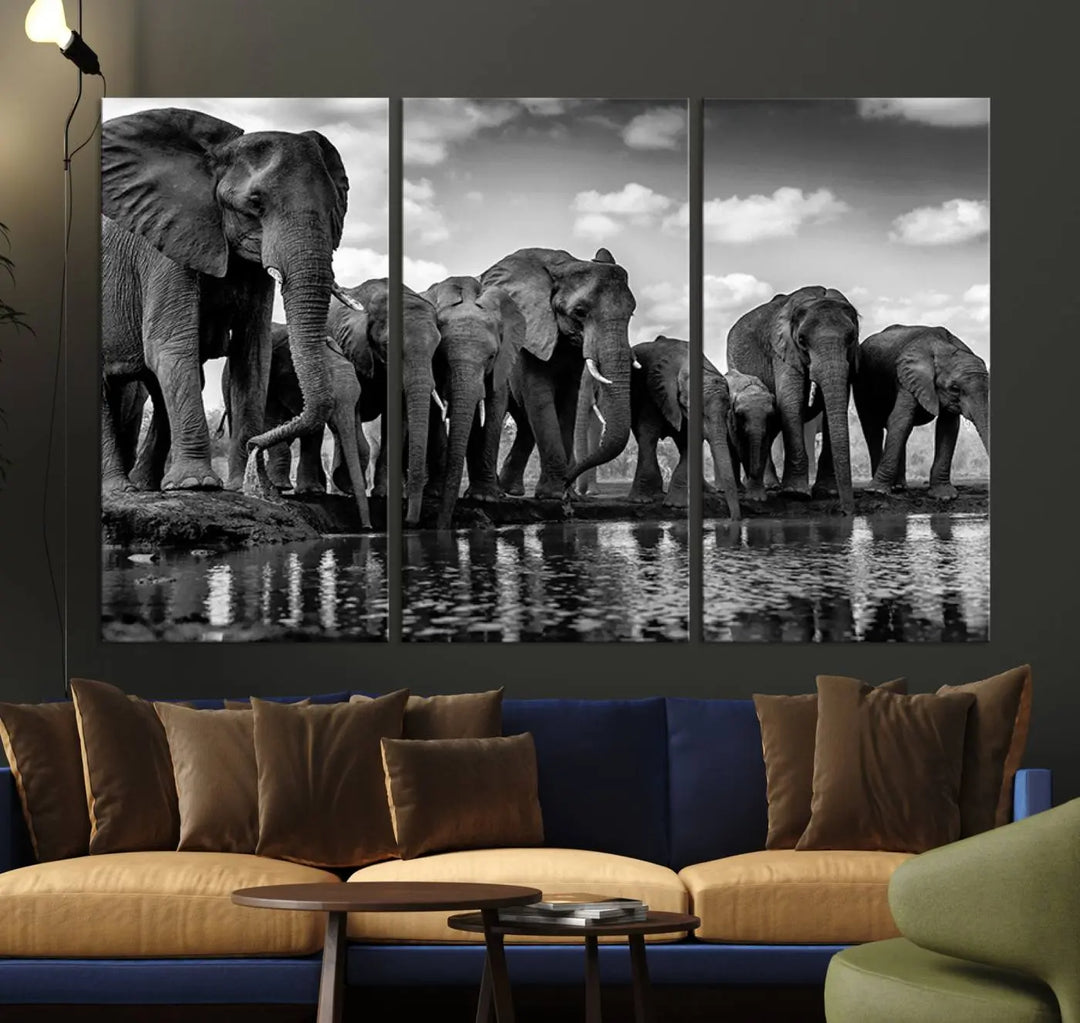 A stunning "Wall Art Animal Canvas Print" featuring a black and white photo of a herd of elephants drinking water is elegantly displayed, gallery wrapped on museum-quality canvas.