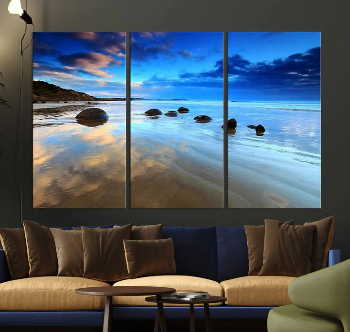 An elegant triptych artwork titled "Wonderful Beach Landscape with Mountain," beautifully displayed on museum-quality canvas, enhances the stylish living room.