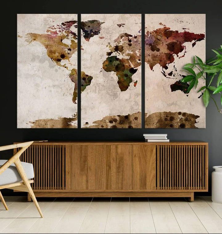 A Watercolor World Map Canvas Print, wrapped in an elegant gallery style, hangs on the wall.