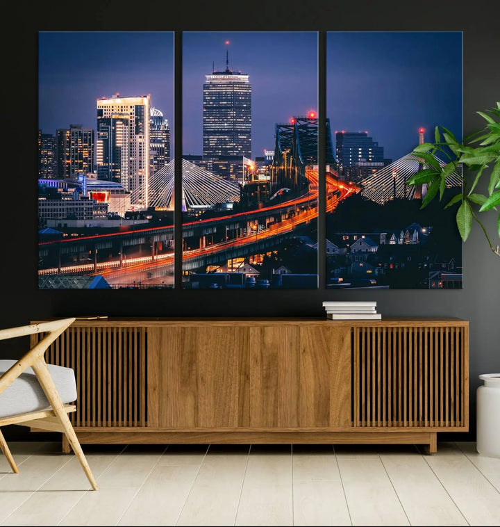 The "Boston City Lights Night Skyline Cityscape View" artwork on the wall showcases a brightly lit bridge at night. It is displayed on museum-quality canvas with a UV-protective coating.