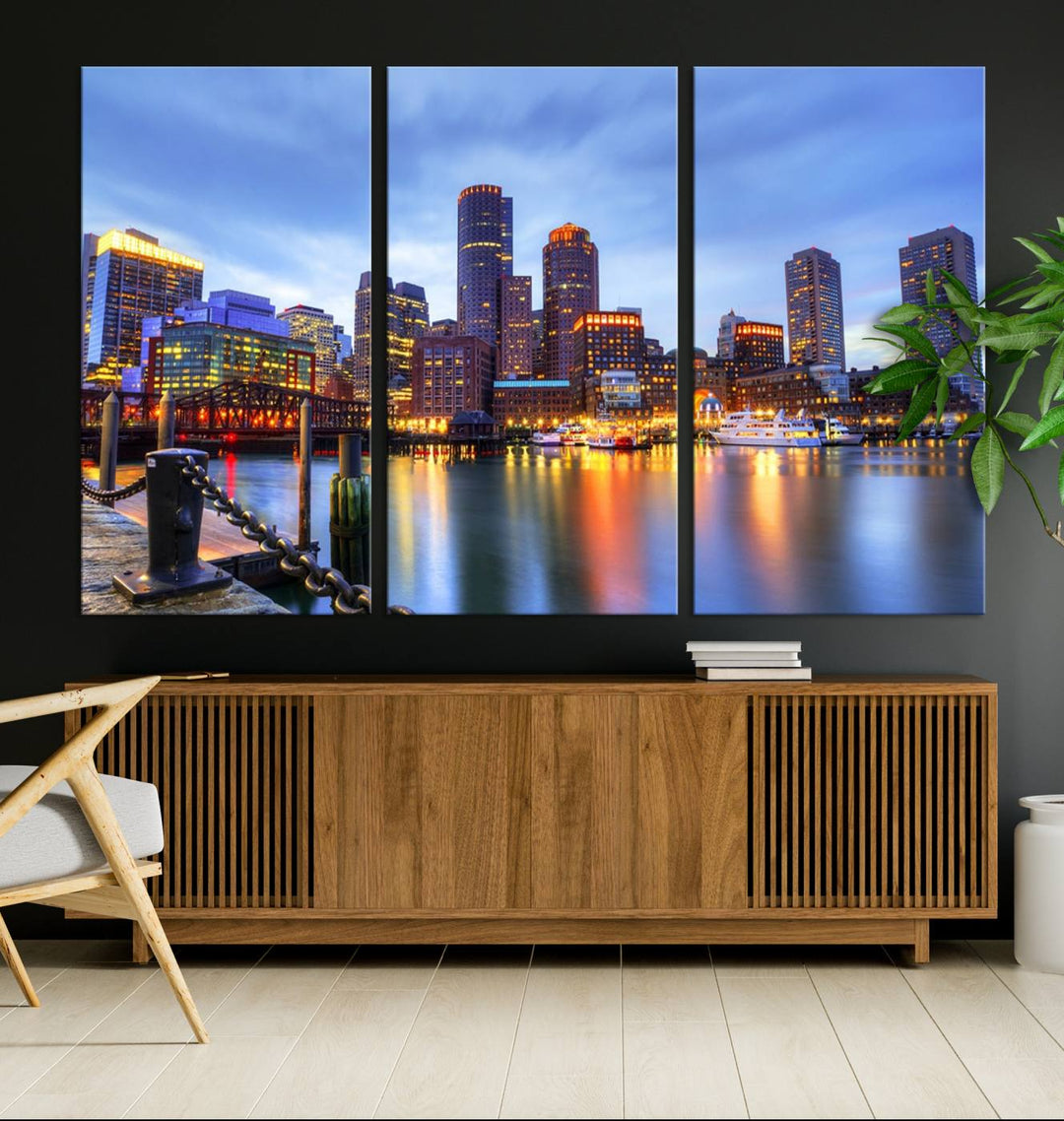 The Boston City Lights Sunset Cloudy Blue Skyline Cityscape View Wall Art Canvas Print embellishes a contemporary living room. This gallery-wrapped canvas set guarantees museum-quality canvases to enhance any space.