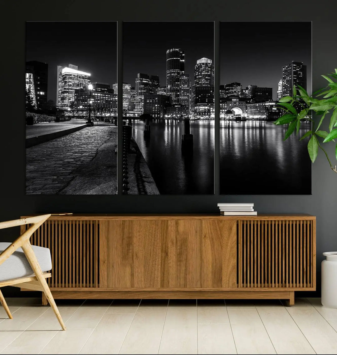 The Boston City Lights Skyline Black and White Wall Art Cityscape Canvas Print portrays a triptych of the city skyline at night reflecting on a calm river. This museum-quality canvas features UV-protective finishes to preserve its timeless allure.