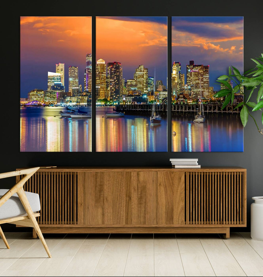 A contemporary dining area features a large triptych wall art of the Boston City Night skyline in blue and orange hues, printed on museum-quality canvases to ensure lasting beauty.