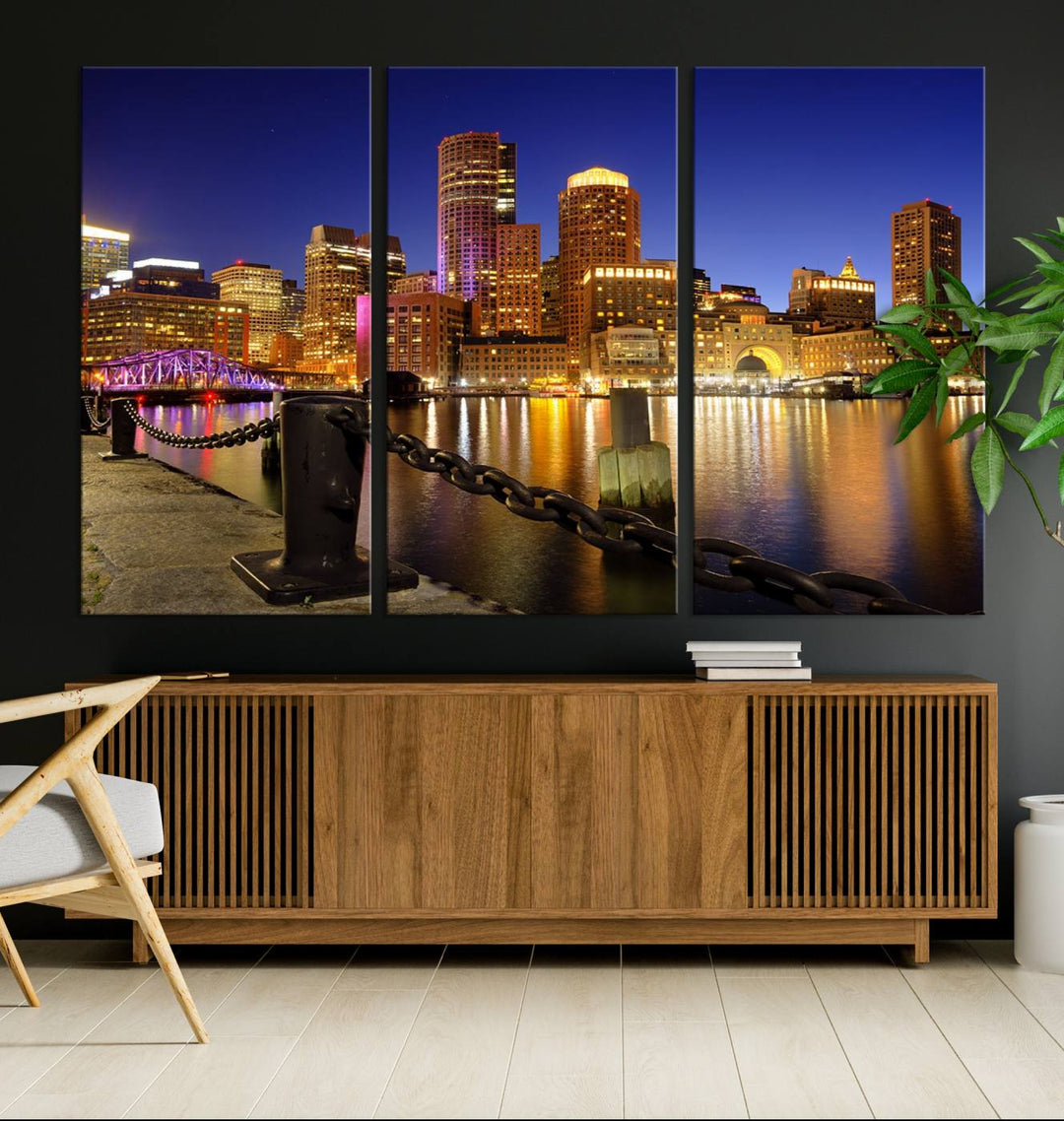 The "Boston City Night Skyline Cityscape View Wall Art Canvas Print" beautifully portrays a stunning triptych of a city skyline illuminated against the night sky, elegantly reflected in the river below. These museum-quality canvases are gallery wrapped to ensure an elegant presentation that enhances any space.