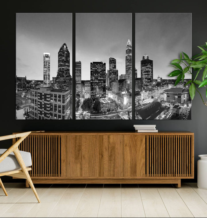 The "Charlotte City Cloudy Skyline Black and White Wall Art Cityscape Canvas Print" hangs on a dark wall, showcasing its UV-protective properties for enduring beauty.