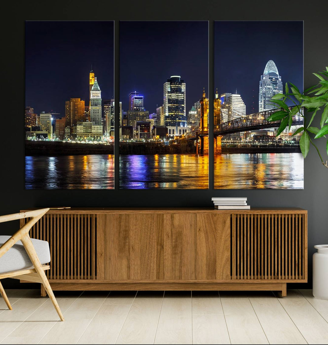 The Cincinnati City Lights Night Skyline Cityscape View Wall Art Canvas Print, crafted on museum-quality canvas with UV-protective coating and ready to hang, adds a touch of sophistication to the wall.