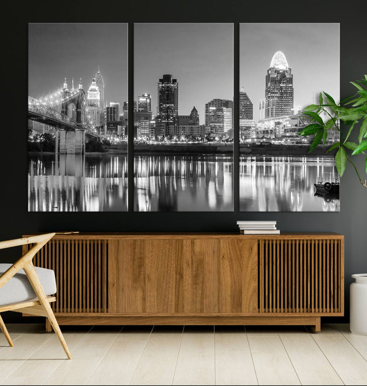 The "Cincinnati City Lights Skyline Black and White Wall Art Cityscape Canvas Print" is elegantly displayed in a stylish living room.