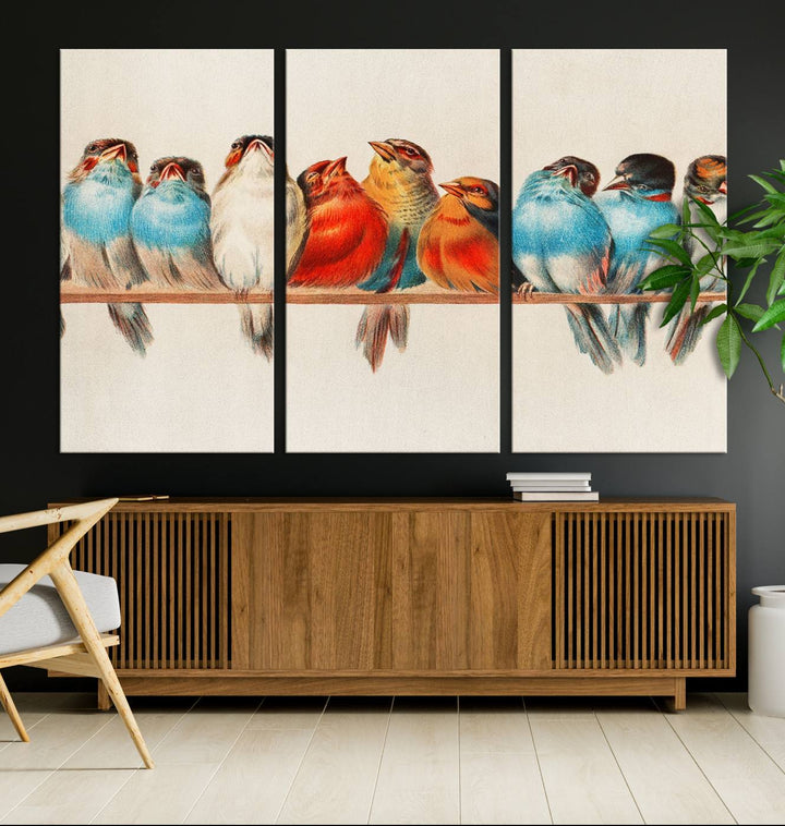 The Abstract Birds Wall Art Canvas Print, featuring a triptych of colorful birds perched on a branch, is printed on museum-quality canvas and equipped with a UV-protective coating and ready-to-hang design. This artwork adds vibrant elegance to your living space.