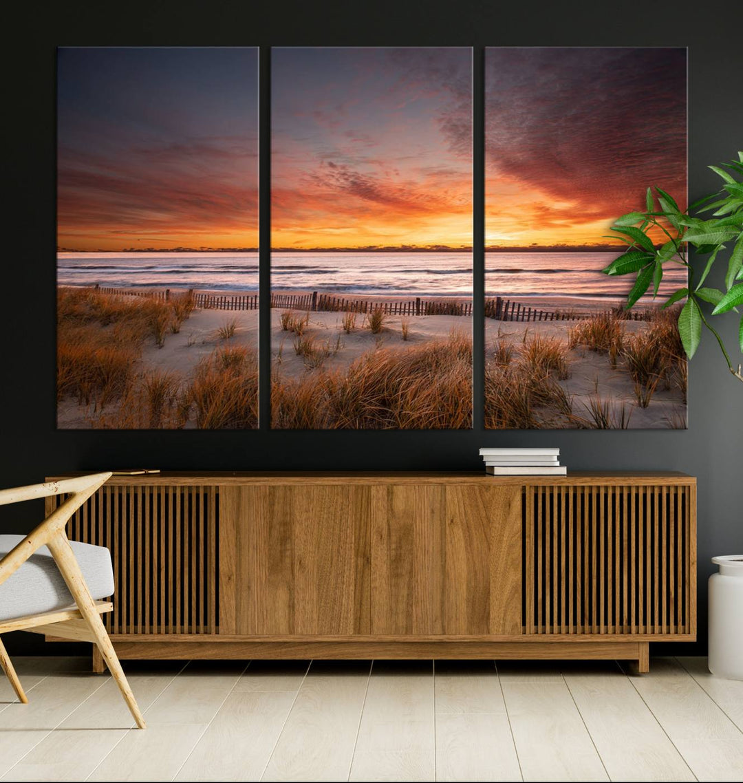 Sunset on The Beach Wall Art Canvas Print features a triptych of a beach at sunset with vivid orange skies, presented on museum-quality canvas. Each section is gallery wrapped, offering lasting beauty with its UV-protective coating.