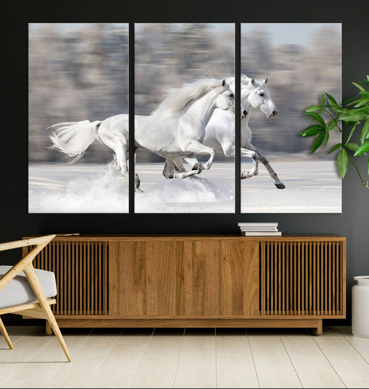 The "All The White Horses Wall Art Canvas Print" depicts a triptych of galloping white horses across a snowy landscape. These museum-quality canvases come with a UV-protective coating to maintain their stunning appearance over time.