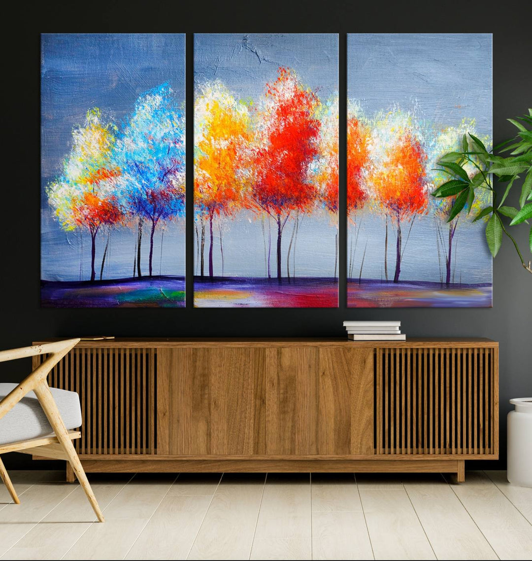 A triptych of the Abstract Colorful Trees Wall Art Canvas Print, gallery-wrapped on museum-quality canvas, adorns the wall.