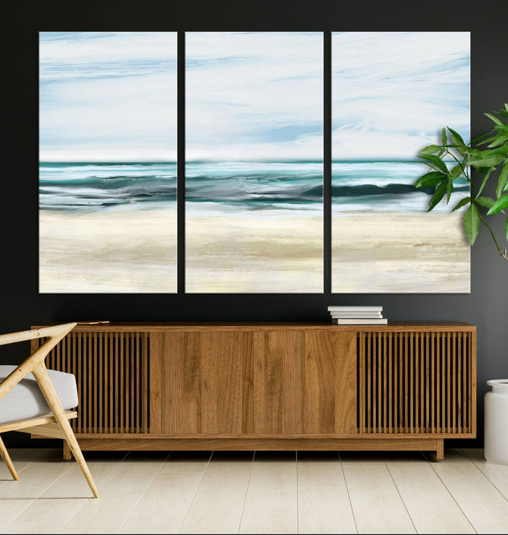 The room features the Ocean Abstract Wall Art Canvas Print, a triptych beach painting on museum-quality canvas with a gallery-wrapped finish and UV-protective coating.