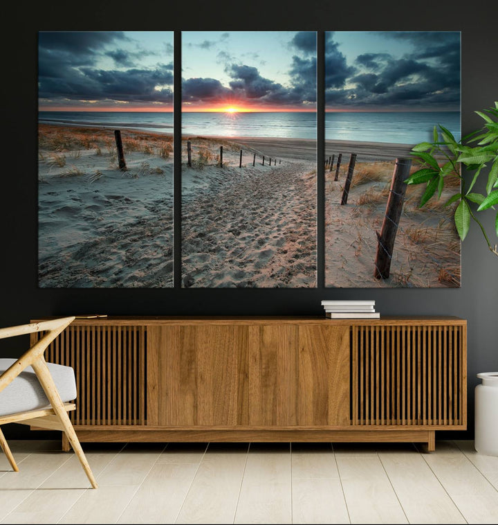 The modern living room features the Cloudy Weather Sunset Beach Wall Art Canvas Print. This museum-quality canvas adds a touch of sophistication with its hand-assembled framed art, ensuring lasting elegance. Enjoy free shipping on this exquisite piece.