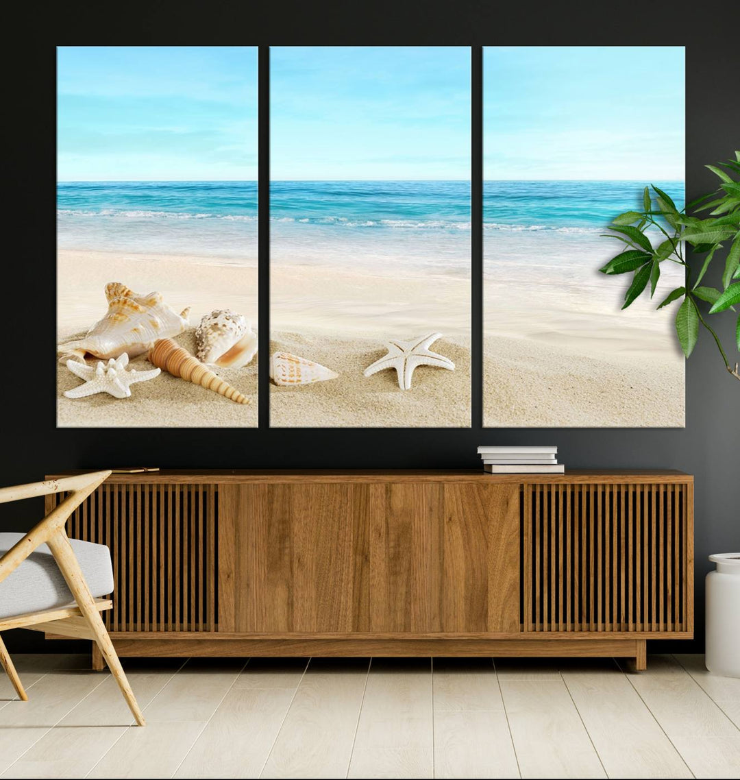 The "Turquoise Ocean View Seashell Starfish on the Beach Canvas Print Artwork" is a triptych piece that showcases a tranquil beach scene, complete with seashells and starfish adorning the sand. It is elegantly gallery-wrapped on museum-quality canvas.