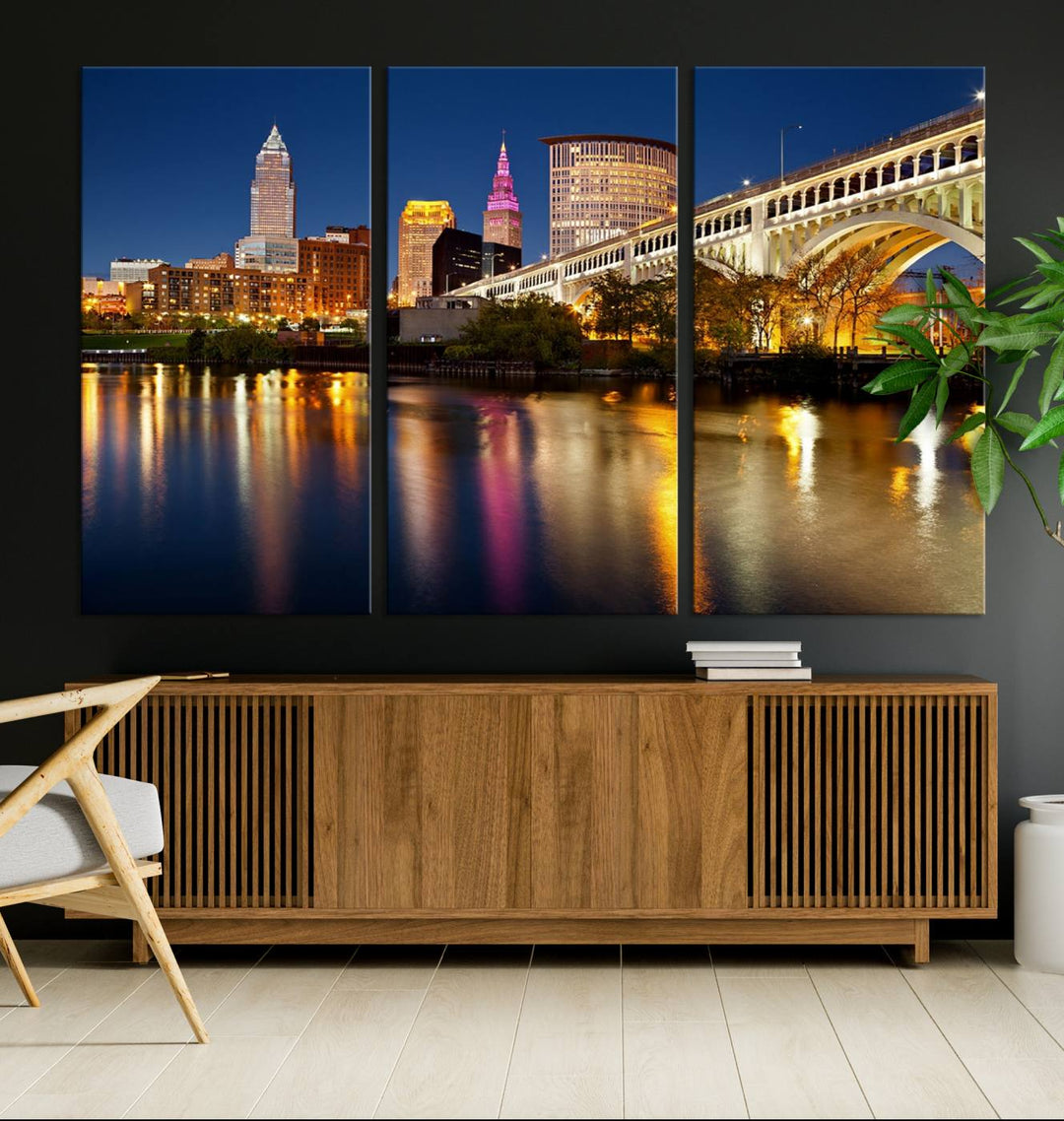 The "Cleveland Night Skyline Wall Art City Cityscape Canvas Print" is a striking feature in the room, showcasing a city skyline with a bridge reflecting in a river. Displayed on museum-quality canvas, it offers enduring beauty.