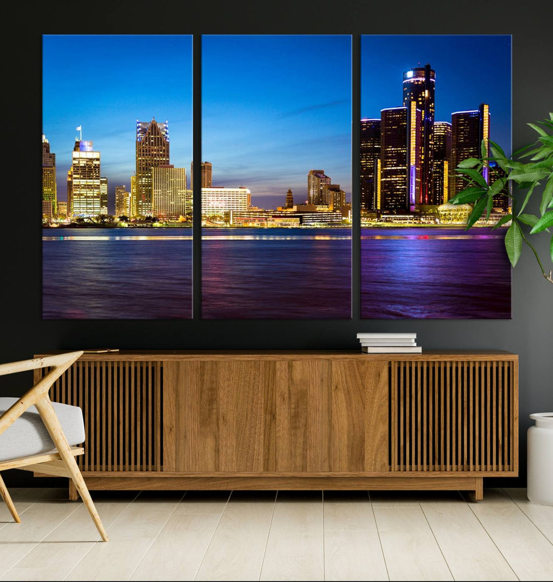 The living room features a breathtaking canvas print titled "Detroit City Lights Night Bright Blue Skyline Cityscape View," presented in a stunning triptych format on museum-quality canvases that are ready to hang.