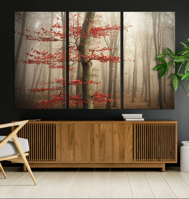 Foggy forest wall art with autumn trees and red leaves, 3-panel canvas print displayed in living room.