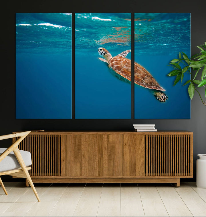 The living room features the "Baby Turtle in Ocean" wall art canvas print. This gallery-quality piece, depicting a sea turtle swimming underwater, adds an elegant touch to the space.