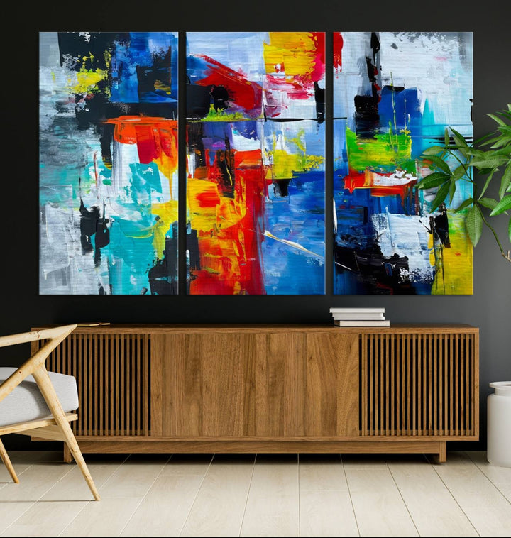 Three Colorful Abstract Wall Art Canvas Prints feature vibrant colors on museum-quality canvas and are finished with a UV-protective coating. Their ready-to-hang design allows for effortless transformation of your space.