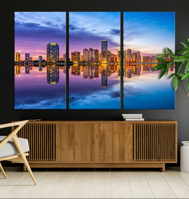 The Miami City Wall Art Canvas Print, featuring a three-panel depiction of a city skyline at sunset reflected in water, beautifully enhances the wall. Made with museum-quality canvas and a UV-protective coating, it comes ready to hang.