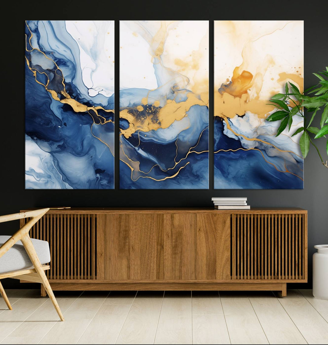 A contemporary living room featuring the "Navy Blue Gold Abstract Wall Art Canvas Print" on the wall, displayed on a gallery-wrapped, museum-quality canvas.