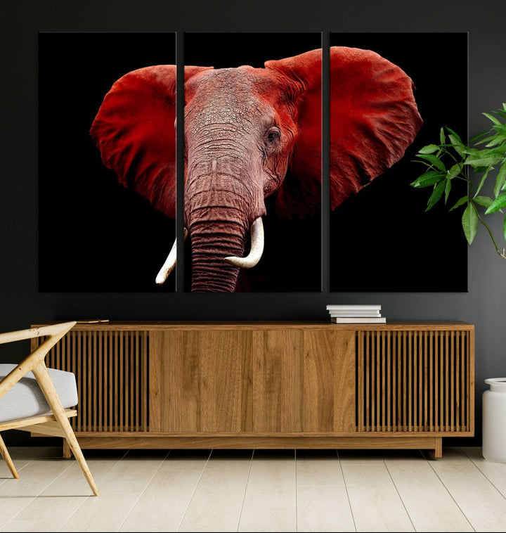 A Wall Art Canvas Print in the modern living room features a three-panel premium design of a red elephant face.