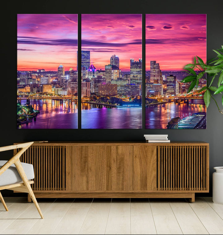 The Pittsburg Wall Art Canvas Print, showcasing a vibrant sunset glow over the city skyline and crafted by a professional artisan, adorns the space.