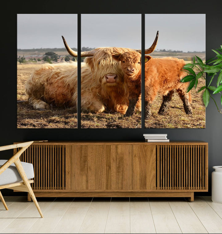 The three-panel canvas artwork, titled "Highland Cow Canvas Wall Art Animal Print for Farm House Decor," features a serene scene of a resting Highland cow and calf in a field. The piece highlights its gallery-quality finish.